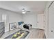 Bright bedroom with gray walls, wood-look floors, and a ceiling fan at 5206 Whispering Leaf Trl, Valrico, FL 33596