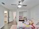 Bedroom with two beds, plenty of stuffed animals, and a ceiling fan at 5206 Whispering Leaf Trl, Valrico, FL 33596