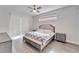 Bright bedroom with king-size bed, wood floors, and ceiling fan at 5206 Whispering Leaf Trl, Valrico, FL 33596