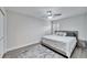 Spacious bedroom with king-size bed, gray walls, and wood-look floors at 5206 Whispering Leaf Trl, Valrico, FL 33596