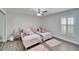 Cozy bedroom with twin beds and window at 5206 Whispering Leaf Trl, Valrico, FL 33596