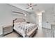Spacious primary bedroom with king bed, walk-in closet, and wood floors at 5206 Whispering Leaf Trl, Valrico, FL 33596