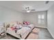 Charming bedroom with twin beds, light walls, and ceiling fan at 5206 Whispering Leaf Trl, Valrico, FL 33596