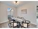 Bright dining area with modern table and chairs, near a large window at 5206 Whispering Leaf Trl, Valrico, FL 33596