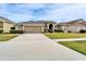 One-story house with attached garage and landscaped lawn at 5206 Whispering Leaf Trl, Valrico, FL 33596