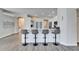 Modern kitchen with white cabinets, quartz countertops, and breakfast bar at 5206 Whispering Leaf Trl, Valrico, FL 33596