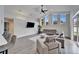Spacious living room with high ceilings, large windows, and modern furniture at 5206 Whispering Leaf Trl, Valrico, FL 33596