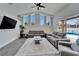 Spacious living room with vaulted ceilings, gray sectional, and pool access at 5206 Whispering Leaf Trl, Valrico, FL 33596