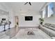 Spacious living room with vaulted ceilings, gray sectional sofa, and large TV at 5206 Whispering Leaf Trl, Valrico, FL 33596