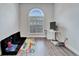Room with hardwood floors, large window, and play area at 5206 Whispering Leaf Trl, Valrico, FL 33596