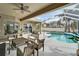 Covered patio area overlooking a refreshing pool at 5206 Whispering Leaf Trl, Valrico, FL 33596