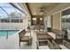 Relaxing pool area with covered patio, outdoor kitchen, and seating at 5206 Whispering Leaf Trl, Valrico, FL 33596