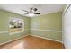 Light-filled bedroom with wood flooring and ceiling fan at 5332 Nutcracker Cir, Land O Lakes, FL 34639