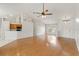 Open concept living room with hardwood floors, kitchen view, and access to backyard at 5332 Nutcracker Cir, Land O Lakes, FL 34639