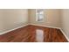 Spacious bedroom with wood-look flooring and large window at 5809 War Admiral Dr, Wesley Chapel, FL 33544