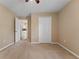 Bedroom with carpet flooring, ceiling fan, and kitchen view at 5809 War Admiral Dr, Wesley Chapel, FL 33544