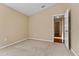 Bright bedroom with carpet flooring and access to hallway at 5809 War Admiral Dr, Wesley Chapel, FL 33544