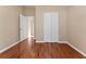 Bright bedroom featuring wood-look floors and a roomy closet at 5809 War Admiral Dr, Wesley Chapel, FL 33544