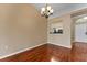 Bright dining room with hardwood floors and view into kitchen at 5809 War Admiral Dr, Wesley Chapel, FL 33544