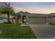 One-story house with attached garage, landscaped lawn, and palm trees at 5809 War Admiral Dr, Wesley Chapel, FL 33544