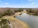 Aerial view of a golf course with a lake at 5809 War Admiral Dr, Wesley Chapel, FL 33544
