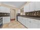 Kitchen with white cabinets, stainless steel appliances, and tile floor at 5809 War Admiral Dr, Wesley Chapel, FL 33544