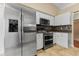Stainless steel appliances and white cabinetry in this kitchen at 5809 War Admiral Dr, Wesley Chapel, FL 33544