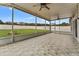 Spacious screened patio overlooking a grassy backyard at 5809 War Admiral Dr, Wesley Chapel, FL 33544