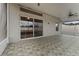 Covered patio with tile floors, sliding glass doors and ceiling fan at 5809 War Admiral Dr, Wesley Chapel, FL 33544