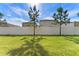Private backyard with grassy lawn and privacy fence at 7227 Sweet Alyssum Ct, Tampa, FL 33619