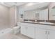 Bathroom with double vanity, shower, and granite countertop at 7227 Sweet Alyssum Ct, Tampa, FL 33619