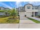 Front view of a two-story townhouse, showcasing garage and landscaping at 7227 Sweet Alyssum Ct, Tampa, FL 33619