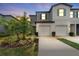 Two-story townhouse exterior at dusk, showcasing landscaping and driveway at 7227 Sweet Alyssum Ct, Tampa, FL 33619