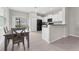 Modern kitchen with white cabinets and black appliances at 7227 Sweet Alyssum Ct, Tampa, FL 33619