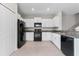 Modern kitchen with white cabinets and black appliances at 7227 Sweet Alyssum Ct, Tampa, FL 33619
