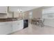 Eat-in kitchen with white cabinets and granite countertops at 7227 Sweet Alyssum Ct, Tampa, FL 33619
