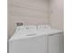 Bright laundry room with washer and dryer, and overhead shelving at 7227 Sweet Alyssum Ct, Tampa, FL 33619