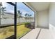 Screened patio with view of grassy backyard at 7227 Sweet Alyssum Ct, Tampa, FL 33619
