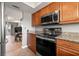 Well appointed kitchen with stainless appliances, granite countertops, and an open view to the dining area at 90 S Highland Ave # 1306, Tarpon Springs, FL 34689