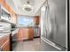Light filled kitchen featuring stainless steel appliances and granite countertops at 90 S Highland Ave # 1306, Tarpon Springs, FL 34689