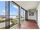 Lanai with wood floors and beautiful views of the lake and community pool at 90 S Highland Ave # 1306, Tarpon Springs, FL 34689