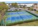 Aerial view of well-maintained tennis courts with lush landscaping offers an active lifestyle in the community at 90 S Highland Ave # 1306, Tarpon Springs, FL 34689