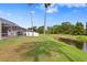 Landscaped backyard with pool and water view at 10025 Cypress Shadow Ave, Tampa, FL 33647