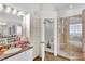 Bathroom with a large shower, separate tub, and double vanity at 10025 Cypress Shadow Ave, Tampa, FL 33647