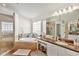 Bathroom with double vanity, soaking tub, and walk-in shower at 10025 Cypress Shadow Ave, Tampa, FL 33647