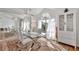 Bright dining room with glass table, white chairs, and large mirror at 10025 Cypress Shadow Ave, Tampa, FL 33647