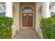 Double wooden doors with arched window and brick entryway at 10025 Cypress Shadow Ave, Tampa, FL 33647