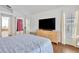 Main bedroom with ensuite bathroom access and large TV at 10025 Cypress Shadow Ave, Tampa, FL 33647