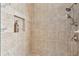 Walk-in shower with tile surround and built-in shelf at 10025 Cypress Shadow Ave, Tampa, FL 33647