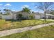 Side view of the house showcasing landscaping and a large yard at 10079 83Rd Way, Seminole, FL 33777